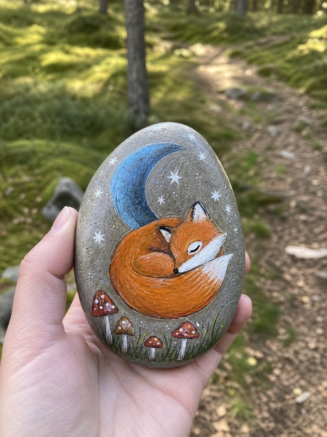 A painted sleeping fox stone in the forest